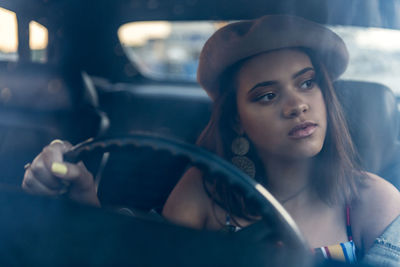 Portrait of young woman in car