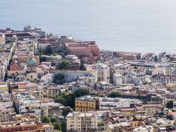 High angle view of townscape by sea