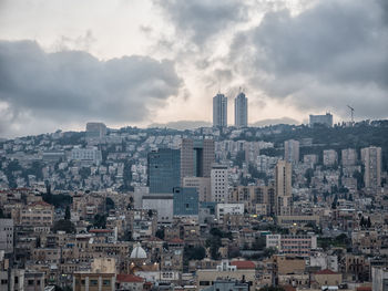 High angle view of city against cloudy sky