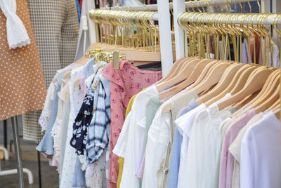 Clothes hanging in row at store