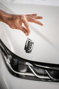 Cropped hand of man holding car