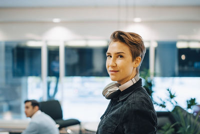 Portrait of young businesswoman standing in office