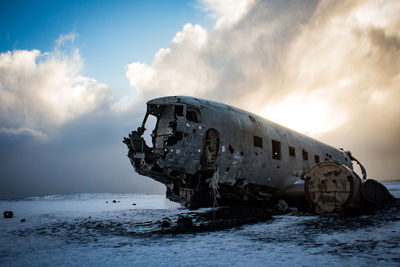 Abandoned airplane on snowy land during winter