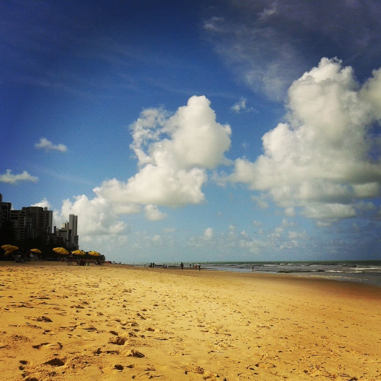 beach, sand, sea, sky, shore, water, horizon over water, tranquility, tranquil scene, scenics, blue, beauty in nature, coastline, nature, cloud - sky, cloud, built structure, building exterior, architecture, incidental people