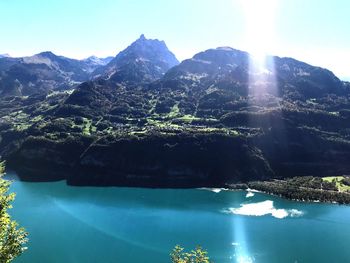 Scenic view of lake and mountains against sky