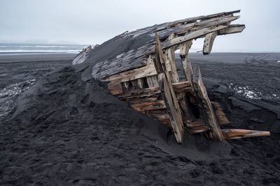 Built structure on beach against sky