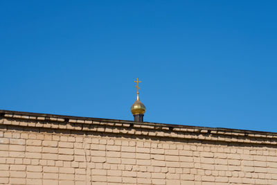 Low angle view of building against clear blue sky