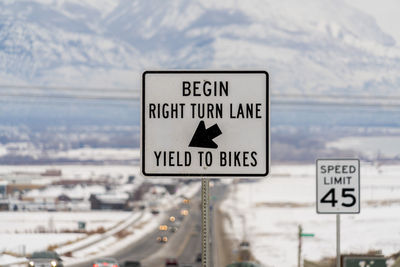 Road sign against sky