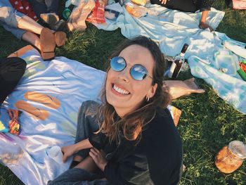 High angle portrait of smiling young woman wearing sunglasses