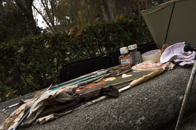 Close-up of book on table against trees