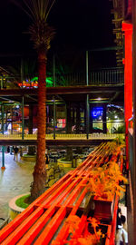 Illuminated railroad station in city at night