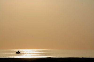 Scenic view of sea against orange sky