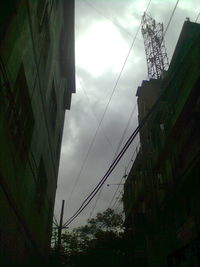 Low angle view of electricity pylon against sky