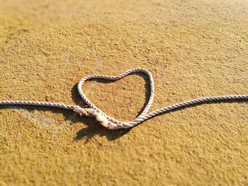 Close-up of heart shape on sand