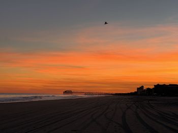 Scenic view of beach against sky during sunset