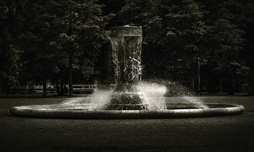 Fountain against trees in park