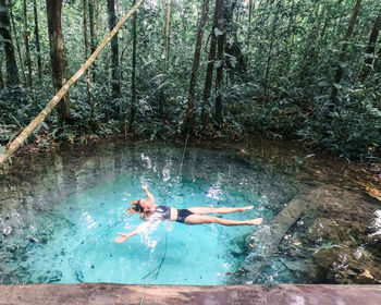 High angle view of woman swimming in water