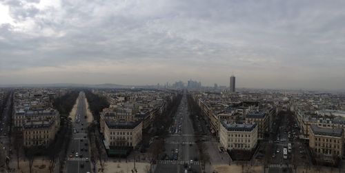 Cityscape against cloudy sky