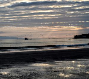 Scenic view of calm sea at sunset