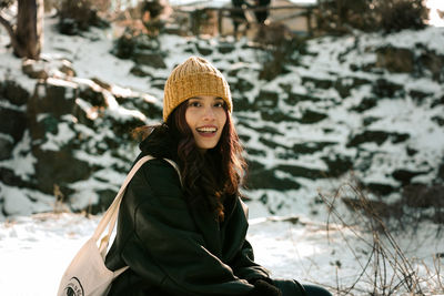 Portrait of smiling young woman in snow