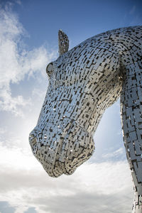 Low angle view of horse statue against sky