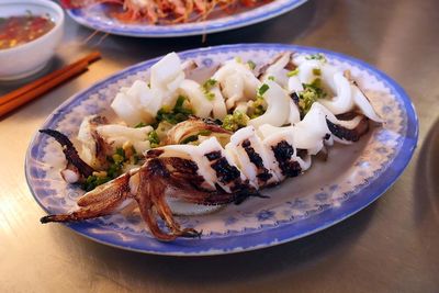 Close-up of cooked squids served in plate on table