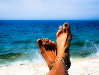 Low section of person relaxing on beach
