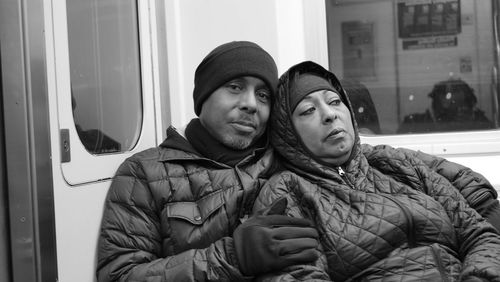 Portrait of couple in warm cloths boarding on metro train