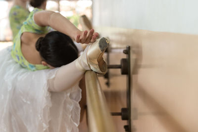 Rear view of father holding girl standing in kitchen