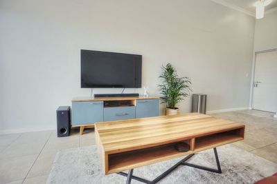 Coffee table with tv in background