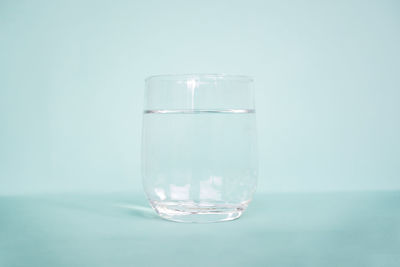 Close-up of glass of water against white background