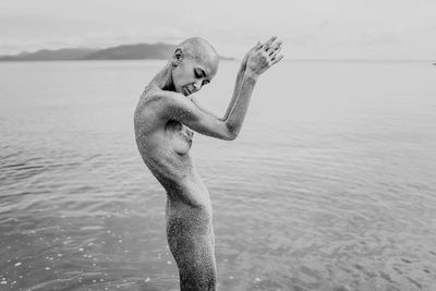 Young bald girl on the beach