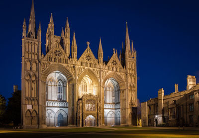 Illuminated cathedral against clear blue sky