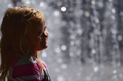 Cute girl looking away by fountain