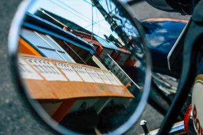 Close-up of reflection on side-view mirror of car