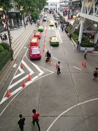 High angle view of people crossing road in city