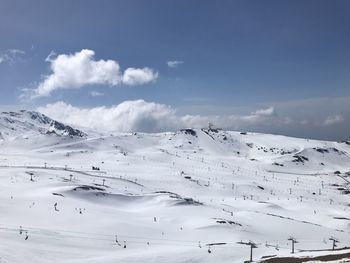 Scenic view of snow covered mountains against sky