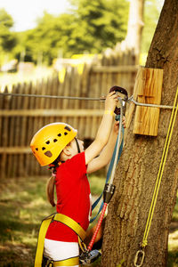 Girl zip lining in forest