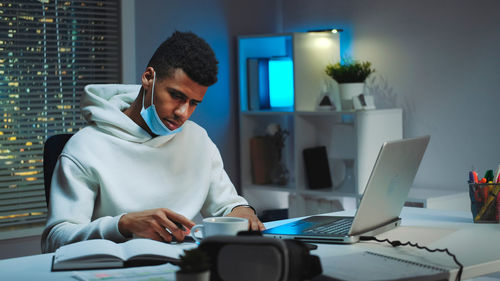 Young woman using laptop at home