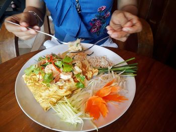 High angle view of man having food on table