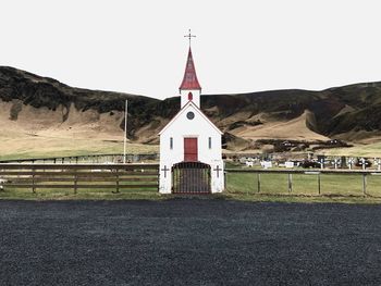 Church by road against sky