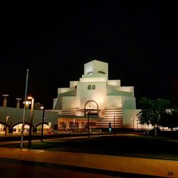 Illuminated church against clear sky at night