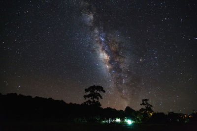 Scenic view of star field over landscape at night