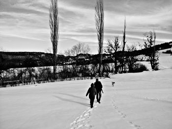 Woman standing on snow covered landscape