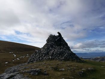 Rock on landscape against sky