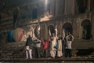 People standing by historic building