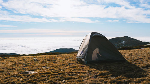 Tent on field against sky