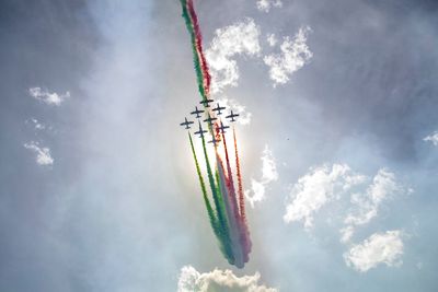 Low angle view of airshow against sky