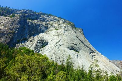 Low angle view of mountain against clear blue sky