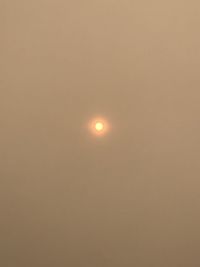 Low angle view of moon against orange sky